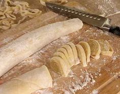 a knife and some bread on a cutting board