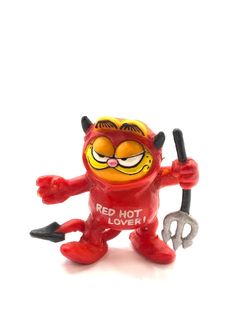 a red toy figure holding a wrench with the words red hot love written on it