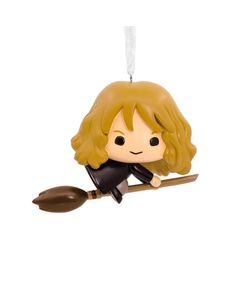 a harry potter christmas ornament hanging from a rope with a broom on it