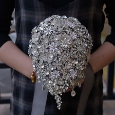 a bridal bouquet being held by a woman