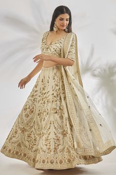 Ivory can can attached lehenga featuring all over zardozi along with pearl embroidered paisley and floral patterns. Comes with matching padded blouse featuring pearl embellished floral motifs highlighted with pearl tassels and matching pearl embroidered dupatta.
Components: 3
Pattern: Embroidered
Type Of Work: Zardozi,Pearl
Neckline: Cut-out
Sleeve Type: Half
Fabric: Dupion Silk
Color: Ivory
Other Details: 
Attached lining
Cut-out back detail
Closure:
Blouse: Back hook
Lehenga: Side tasselled dr Off White Raw Silk Lehenga For Reception, Cream Raw Silk Choli For Reception, Cream Bollywood Gown With Pallu, Bollywood Style Cream Lehenga With Dupatta, Off White Cutdana Choli For Wedding, Bollywood Style Cream Gown With Pallu, Bollywood Cream Gown With Pallu, Off White Wedding Choli With Cutdana, Cream Choli With Zari Work For Wedding