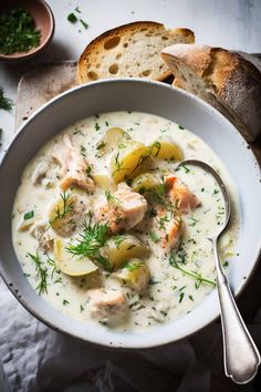 a white bowl filled with soup next to bread