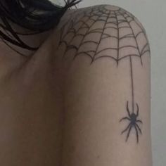 a woman with a spider tattoo on her back