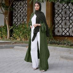 Create the perfect outfit with our Evergreen Open Front Abaya. Designed for women who want to stand out, this unique abaya offers a roomy oversized fit with an open front appeal, adding a soft finishing touch to your look. The textured trim takes it up a notch with a unique flair that will turn heads wherever you go! Abaya Kimono, Abaya Style, Open Abaya, Fashion Muslim, Muslim Outfits, Muslim Dress, المملكة العربية السعودية, Clothing Catalog, Abaya Dress