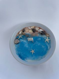 a bowl with shells and starfish in it