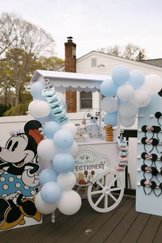 a cart with balloons and mickey mouse decorations