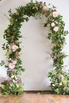 an arch made out of flowers and greenery