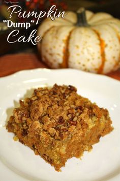 a white plate topped with a piece of pumpkin dump cake