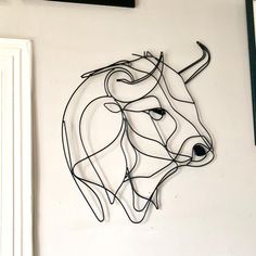 a metal bull head mounted to the side of a wall