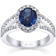 a blue sapphire and diamond ring with white diamonds on the band, set in 18k white gold