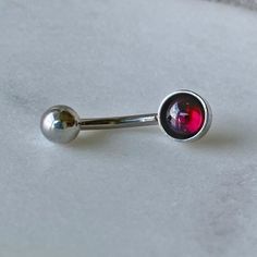 "Garnet Belly Button Ring/316L Surgical Steel/Hypoallergenic/14 Gauge Body Jewelry/Gift for Her/January Birthday Present/Piercing ** Ships out in 1-2 business days! ** ~ These Hypoallergenic bellybutton rings feature a beautiful Natural Garnet Cabochon. ~ Perfect for sensitive skin, making a great gift choice for the \"hard to buy for\" or even a gift for YOURSELF! 💕 M A T E R I A L S: - Genuine Garnet Cabochons - 316L Surgical Steel HYPOALLERGENIC!! DIMENSIONS: - Bar 14 gauge & 12mm in Len Punk Belly Button Piercing, Belly Button Piercing Grunge, Red Belly Button Piercing, Silver Belly Button Piercing, Unique Belly Rings, Bellybutton Rings, Belly Button Piercing Jewelry, Belly Piercing Jewelry, Belly Button Jewelry