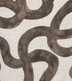 an abstract design with brown and white colors on a light gray groundcloth, in the shape of circles