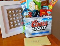 a bag filled with candy and snacks sitting on top of a wooden table next to a white box