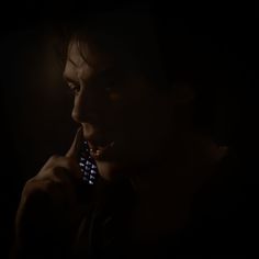 a man talking on a cell phone in the dark