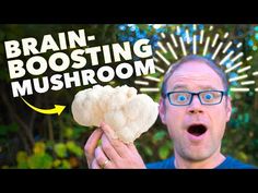 a man holding up a mushroom with the words brain - boostering mushrooms on it