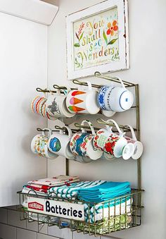 When reusing flea-market finds, think beyond a piece's original purpose to find a creative new use. Here, a vintage retail display rack keeps coffee mugs at-the-ready during breakfast time. The wire basket at the bottom holds stacks of folded dish towels. Ideas Para Organizar, Diy Casa, Vintage Storage, Wood Crates, House Cleaning, Retail Display, House Cleaning Tips, Cups And Mugs