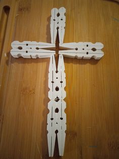 a cross made out of wood sitting on top of a wooden table