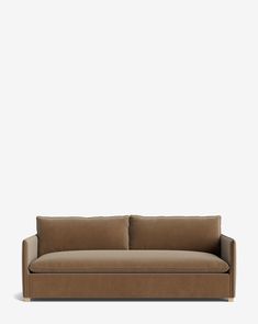 a brown couch sitting on top of a white floor