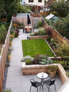 a small backyard garden is shown with tables and chairs