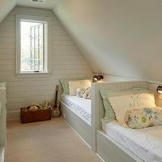 an attic bedroom with two twin beds