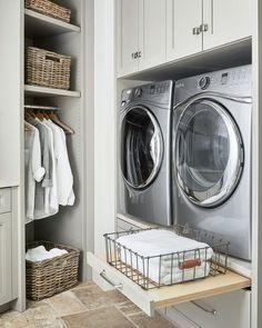 a washer and dryer in a white laundry room