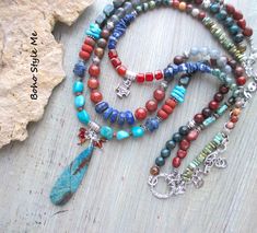 Colorado Springs, Boho Style Me Colorful Rustic Style Multi Strand Gemstone Necklace, BohoStyleMe, Artisan Beaded Turquoise Necklace In the style of the rustic Colorado mountains, this colorful, rustic, mixed gemstone necklace stands out as a striking multiple strand statement necklace. Starting with a beautiful chrysocolla beaded pendant is a trail of genuine turquoise, lapis lazuli, carnelian, labradorite, iolite, sodalite, and a large mix of jasper stones. Directly above the pendant is strand Handmade Multicolor Bohemian Turquoise Necklace, Multicolor Bohemian Turquoise Necklace With Stones, Bohemian Multicolor Turquoise Necklace With Stones, Bohemian Beaded Turquoise Necklace For Meditation, Multicolor Turquoise Bohemian Necklace, Bohemian Multicolor Turquoise Necklace, Multicolor Bohemian Turquoise Necklace With Round Beads, Bohemian Multicolor Turquoise Necklace With Round Beads, Blue Bohemian Beaded Necklaces With Stones