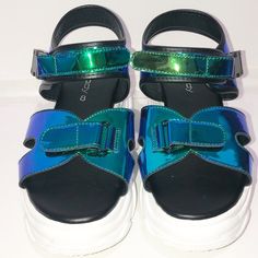 Unilady “Tanya-1” Mix Media Neon Blue Hologram Sandal. Platform Heel With A Sneaker Feel. Buckle Clasp And Velcro. When The Light Hit These The Colors Really Pop. Blues, Greens And Purples. Super Cool And Chic Shoe To Own. New/ Size 8 Trendy Blue Sandals With Ankle Strap, Trendy Blue Sandals For Party, Trendy Blue Party Sandals, Brown Leather Flip Flops, Blush Shoes, Memory Foam Sandals, Dolce Vita Sandals, Tan Leather Sandals, Yellow Sandals