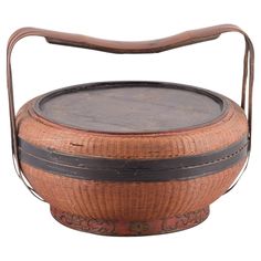 an old wooden basket with leather handles and handle on the bottom, sitting in front of a white background