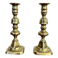 pair of brass candlesticks on white background