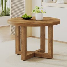 a wooden table with two green apples on top and a bowl of flowers in the middle