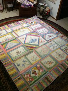 a multicolored quilt on the floor in a living room