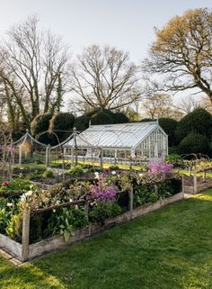 a garden filled with lots of different types of flowers and plants next to each other