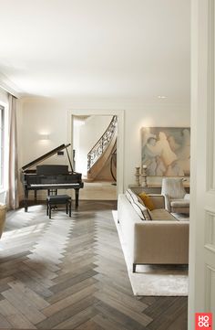 a living room filled with furniture and a grand piano