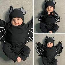 three pictures of a baby wearing a bat costume