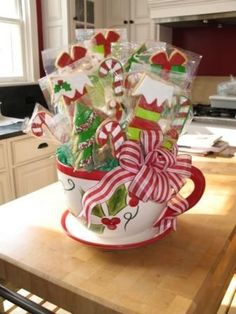 a coffee cup filled with candy canes on top of a counter