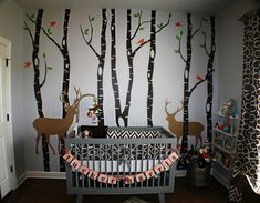 the baby's room is decorated with deer and trees