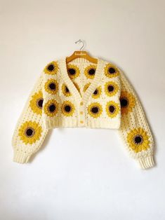 a knitted sweater with sunflowers on it