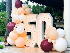 balloons are arranged around the number 50 sign