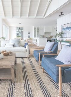 a living room filled with furniture and lots of windows