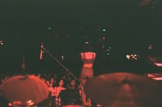 a woman standing on top of a stage in front of an audience at a concert