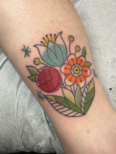 a woman with a flower tattoo on her arm