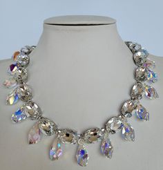 These Anna Wintour style statement necklace is made with beautiful  oval crystals in fabulous Crystal color. The crystals are accentuated beautifully with polygon Swarovski pendants and the nickel setting.  Their versatility makes them perfect for parties and other celebratory gatherings. Quality of the stones and settings makes them a perfect candidate for becoming heirloom pieces. It is elegant, classy and very "Anna Wintour style". Crystals - 13x18 mm Oval point back strass. Crystal Colour - Oval Crystal Necklaces For Parties, Crystal Costume Jewelry Necklace With Sparkling Stones, Costume Crystal Necklaces With Sparkling Stones, Costume Crystal Necklace With Sparkling Stones, Sparkling Crystal Costume Jewelry Necklace, Elegant Multi-strand Crystal Gemstone Necklaces, Exquisite Sterling Silver Multi-stone Necklaces, Multicolor Crystal Rhinestone Necklace, Luxury Silver Multi-stone Bridal Necklace