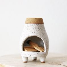 a white ceramic oven with cinnamon sticks in it