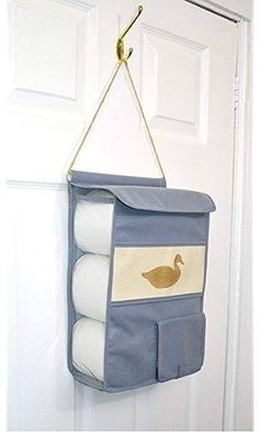 a hanging storage bag with three rolls of toilet paper and a duck on the front