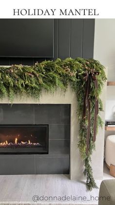 the fireplace is decorated with greenery and candles for holiday mantels on display