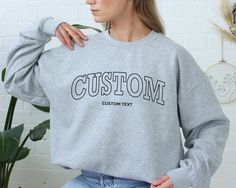 "Trendy Custom College Letters Oversized Sweatshirt, Personalized Crew Neck Sweatshirt, Custom College Letters Women Crew Neck Sweatshirt HOW TO ORDER Please review all the pictures for size chart and color options before making a decision. 1) Choose the t-shirt color (see the color chart and message me if the color you want is not available on the drop down) 2) Choose the t-shirt size 3) Choose the design/text color (Black or White) 4) Choose the quantity 5) Click add to cart 6) Click \"Proceed College Letters, Design Text, Elegant Shirt, Oversized Sweatshirt, Heather Black, Grey Sweatshirt, Text Color, Tank Shirt, Tank Top Shirt