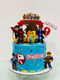 a birthday cake decorated with legos and characters