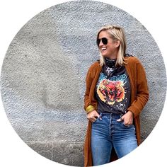 a woman standing in front of a cement wall