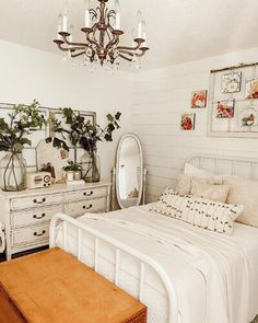 a bedroom with a bed, dressers and a mirror on the wall above it