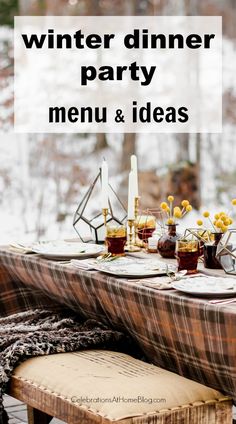 an outdoor dinner party with food and drinks on the table in front of snow covered trees